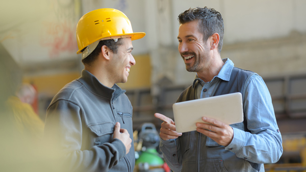 logistics warehouse workers smiling and chatting